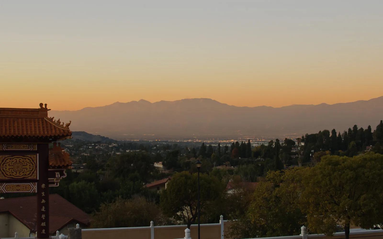 A view of the San Gabriel Valley stretching from the foothills toward distant residential development and the horizon
